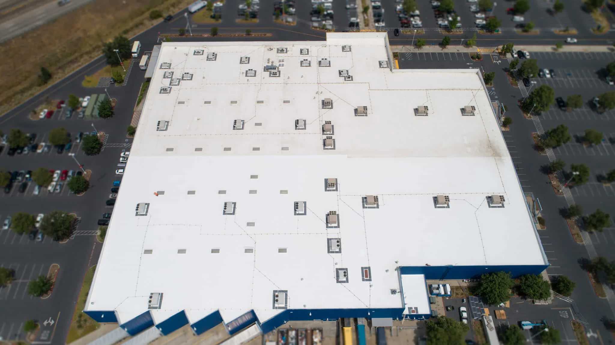 Commercial roof crew installing a low-slope roof system